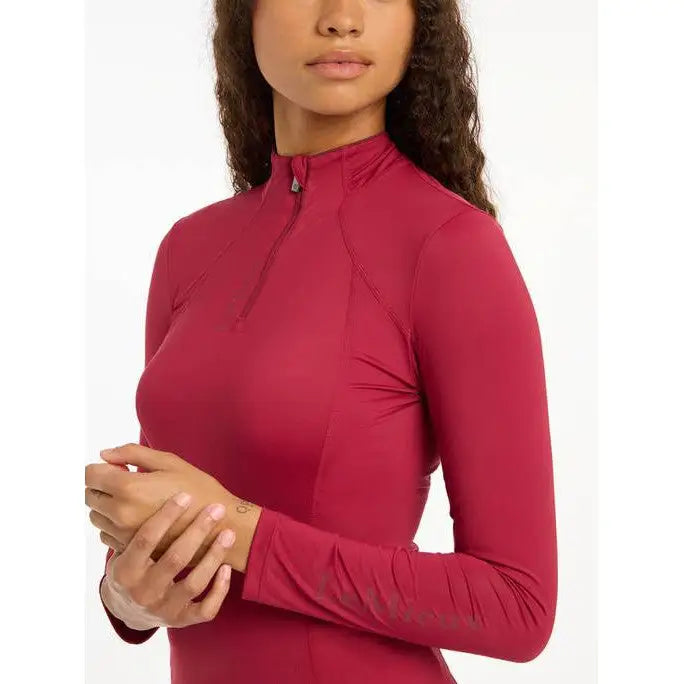 Bright pink long-sleeved athletic top from Lemieux Ladies Base Layer Ember collection