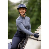 Blue equestrian helmet with subtle logo featured in lemieux ladies base layer jay blue collection for riding safety
