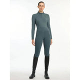 Woman in teal Lemieux Ladies Base Layer Petrol and black riding boots