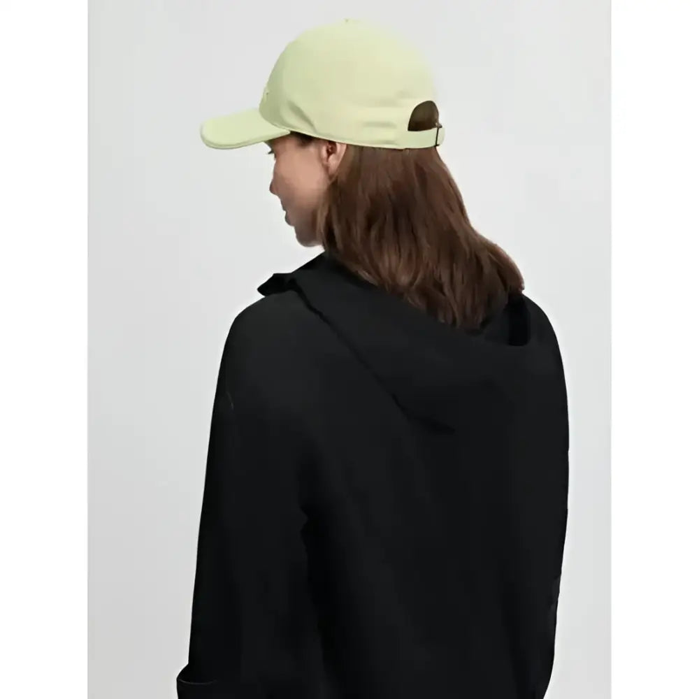 A pale green lara cap macaron made of colourful cotton twill with a curved brim and adjustable back strap