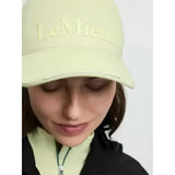 A pale yellow lara cap macaron in colourful cotton twill with a structured shape and lemieux embroidery on front