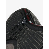 Black mesh athletic shoe with perforated design and red branding detail paired with lemieux le cool grip dressage pad grey featuring anti slip silicone design