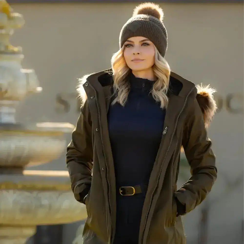 Olive green parka with fur lined hood and black inner lining perfect for pairing with lemieux lila beanie alpine