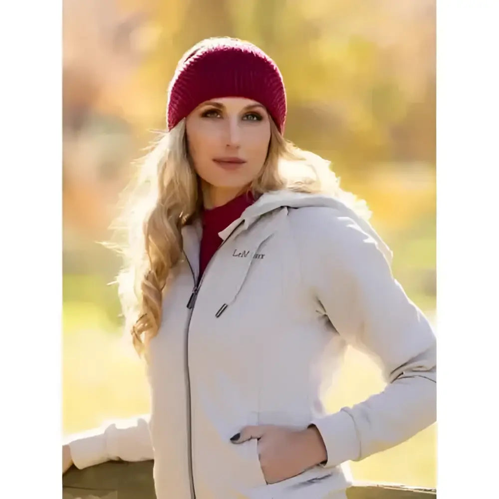 A woman wearing a maroon lemieux lila headband ember with a soft faux fur look and cozy knitted texture
