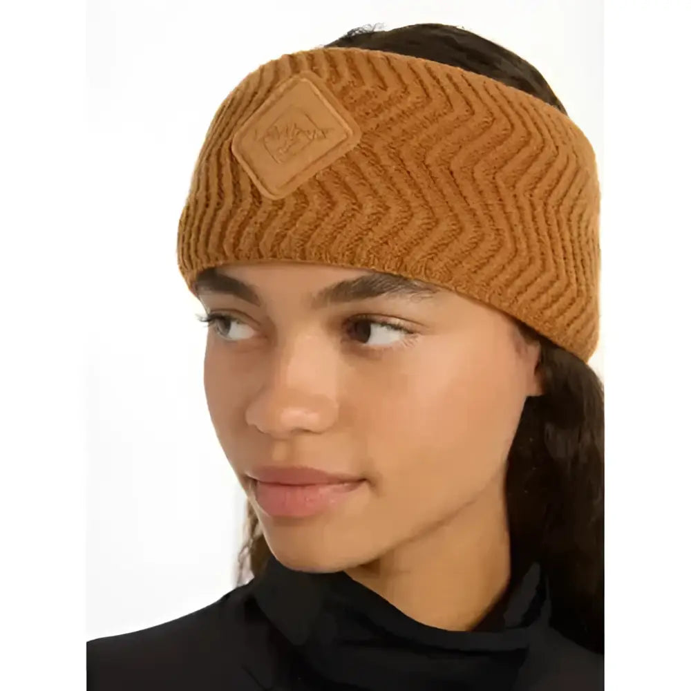 A warm ribbed knit lemieux lila headband ginger in caramel with a tan leather patch and embossed logo