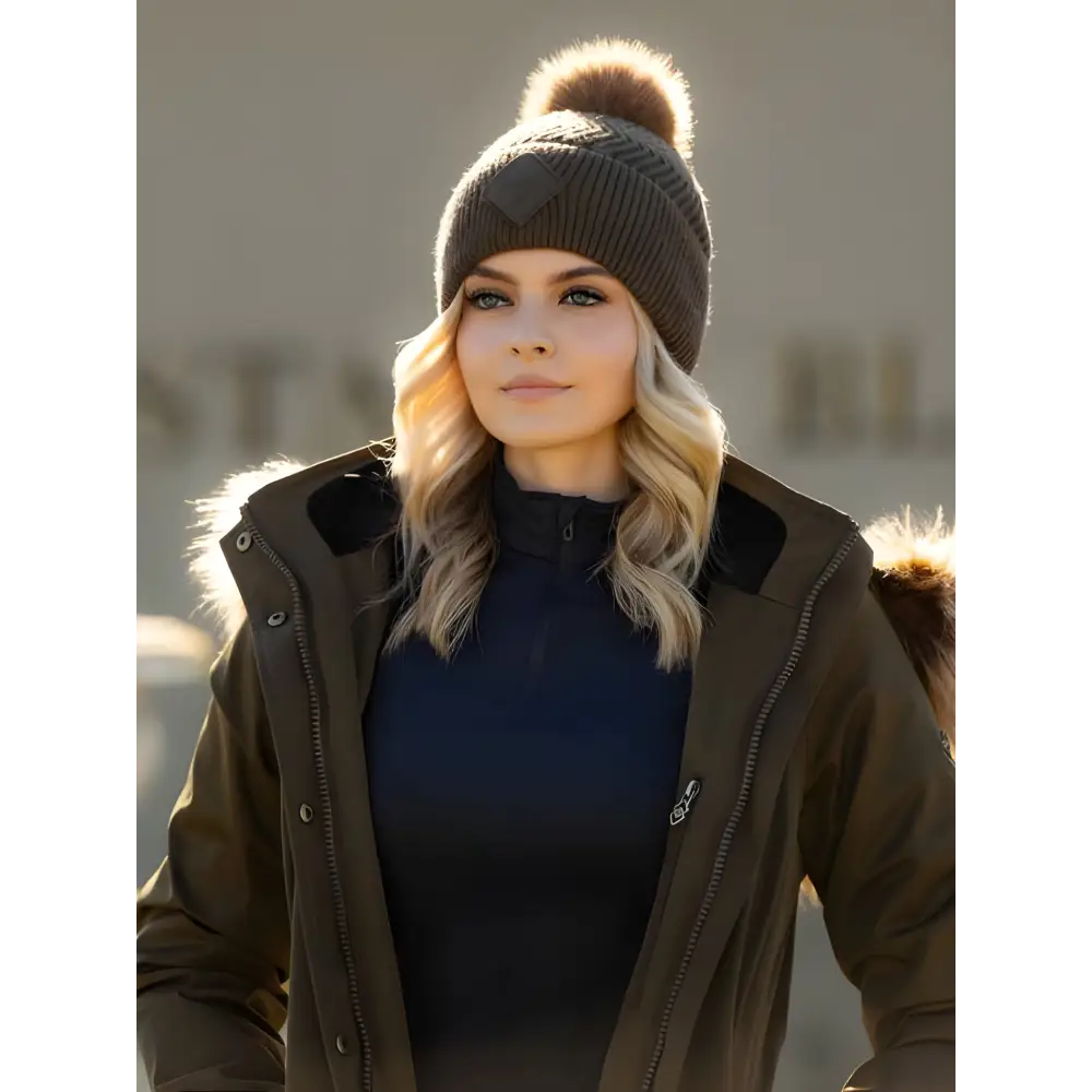 Woman in dark coat and knit Lemieux LM Beanie Alpine with faux fur pom-pom