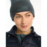 Person in a gray knit Lemieux LM Beanie Petrol and dark puffer jacket with faux fur