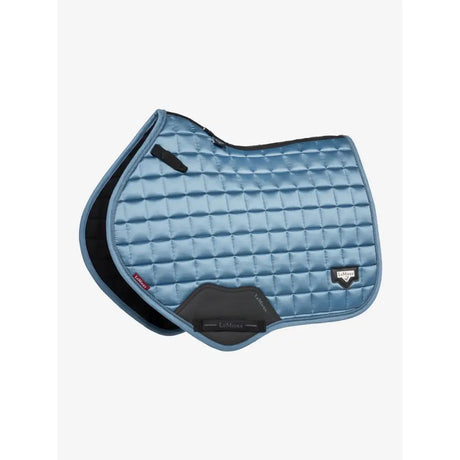 Light blue quilted lemieux loire classic saddle pad with black trim and branded logo patch square ice blue close contact