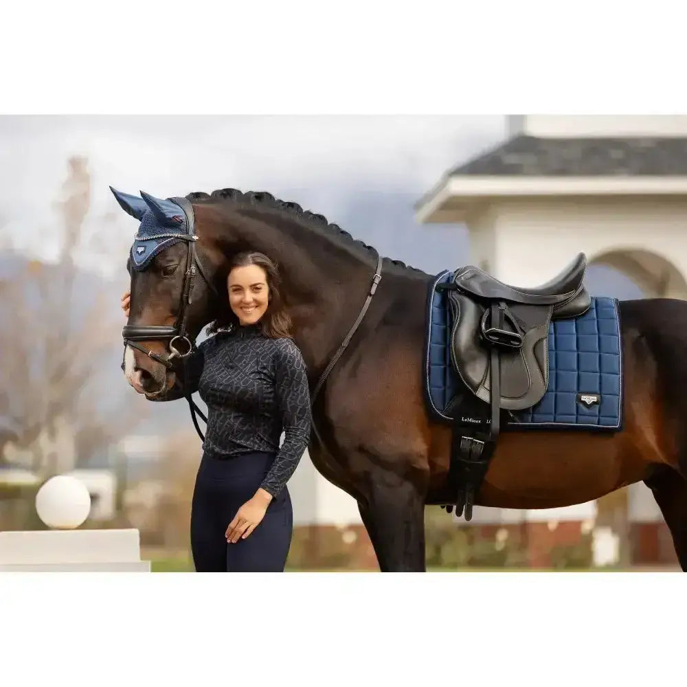 Blue lemieux loire classic dressage pad with woven satin fabric and black leather stirrup with silver hardware