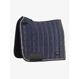 Navy blue quilted lemieux loire classic dressage square dusk saddle pad with beige trim and black fleece lining