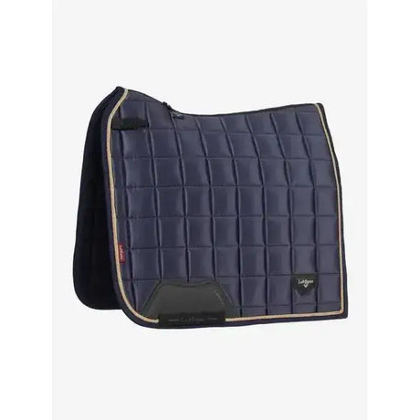 Navy blue quilted lemieux loire classic dressage square dusk saddle pad with beige trim and black fleece lining