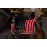 Red quilted saddle pad with black edges and logo patch for lemieux loire classic dressage square ember use