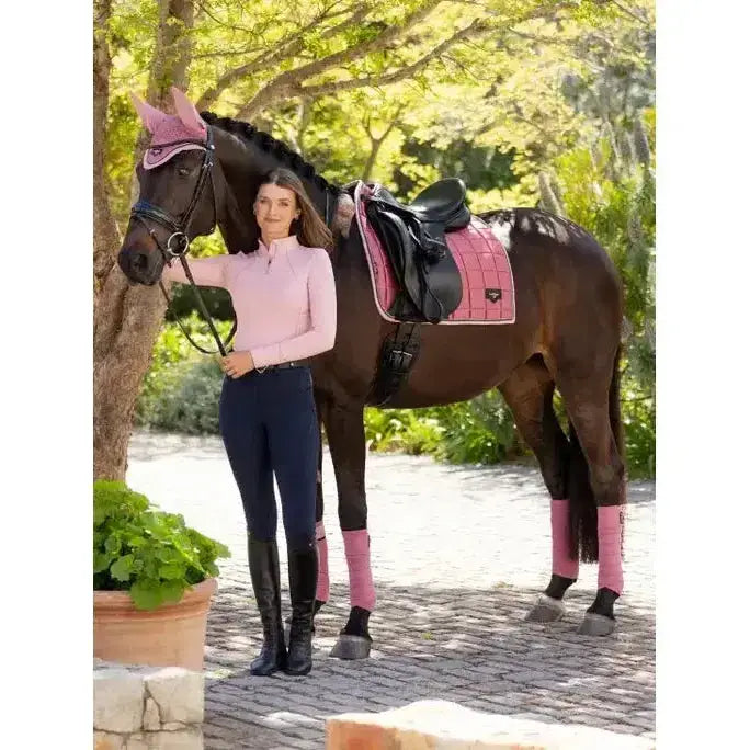 Pink quilted lemieux loire classic dressage square peony saddle pad with black trim and small logo on corner