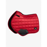 Red quilted lemieux loire close contact saddle pad with black trim and protective panel front for close contact use