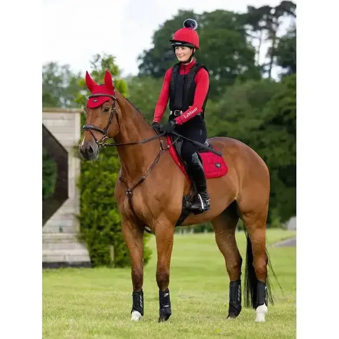 Red lemieux loire close equestrian helmet with black pom pom featuring close contact square chilli design