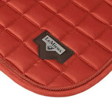 Red quilted lemieux loire memory satin dressage square with brown leather patch and lemieux logo in sienna color