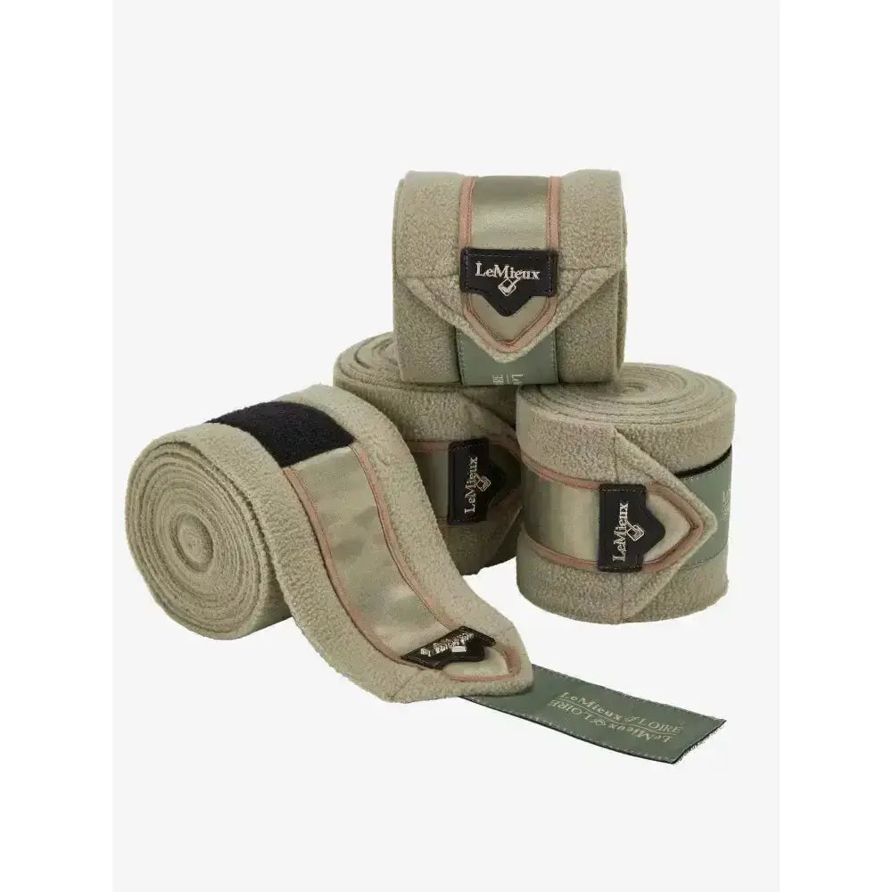 Beige plush lemieux loire polo bandages with black and pink trim and embossed metal motif perfect match wrap rolls