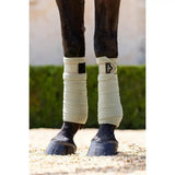 Cream-colored lemieux loire polo bandages with soft texture, black velcro strap, and embossed metal motif perfect match