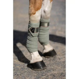 Light green lemieux loire polo bandages with wrap-around design silver embossed metal motif and black brand patch perfect match