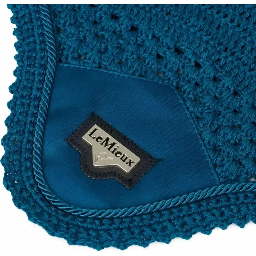 Teal crocheted horse blanket with satin-lined interior and lemieux patch highlighting signature lemieux loire satin design