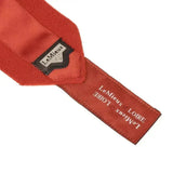 A vibrant red lemieux loire satin tie with sleek satin finish and black-stitched label from loire satin polo bandages set