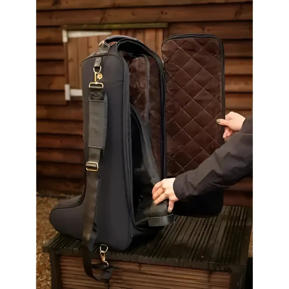 Black quilted lemieux luxe boot bag with plush faux fur lining and adjustable shoulder strap for easy carrying