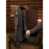 Black quilted lemieux luxe boot bag with plush faux fur lining and adjustable shoulder strap for easy carrying