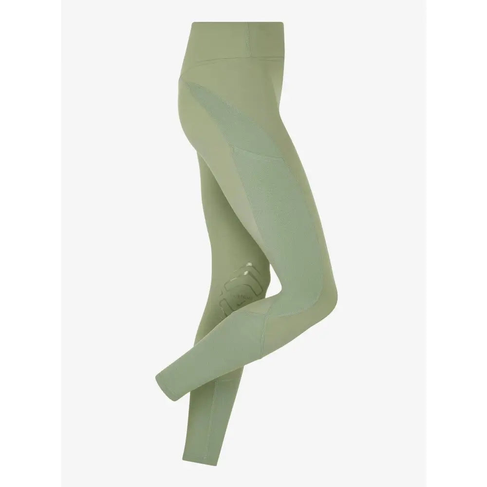 A pair of sage green lemieux lydia mesh leggings with high waist and textured knee patches in mesh legging thyme color