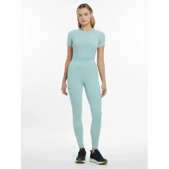 A sleek mint-green two-piece athletic set featuring lemieux lydia mesh leggings aqua made of stretchy fabric