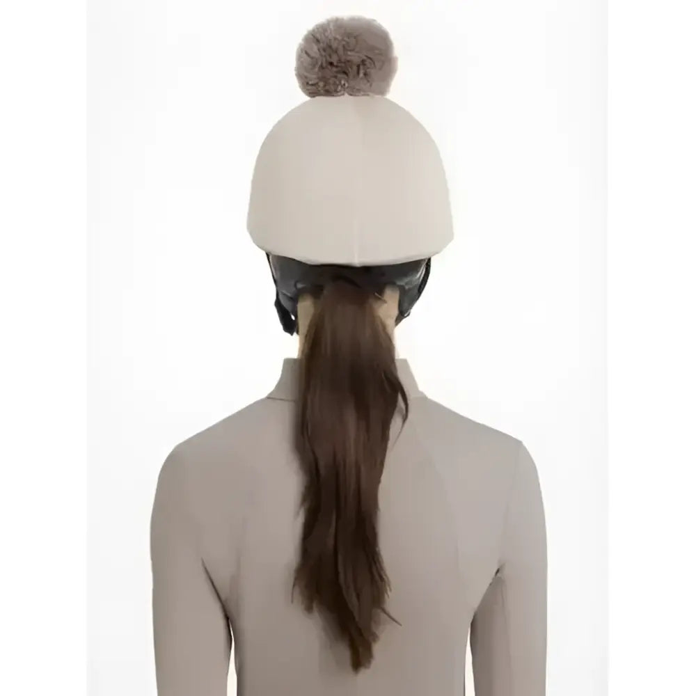 Cream-colored knit lemieux maria mesh hat with a fluffy gray pom pom perfect for cozy winter wear