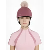 A maroon lemieux maria mesh equestrian helmet with a fluffy pink pom-pom in silk rosewood color