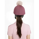 A soft mauve knit beanie with a fluffy beige pom pom from lemieux maria mesh hat silk rosewood collection