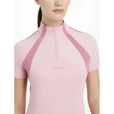 A soft pink lemieux maria mesh short sleeve baselayer blossom top with high collar and darker pink shoulder panels