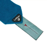 A vibrant blue plush fleece lemieux marine classic scarf with black brand tag and teal woven label with red accent