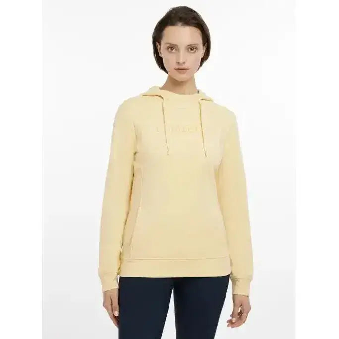 A soft pale yellow lemieux martha hoodie with a hood and subtle embroidered logo across the chest in mimosa color