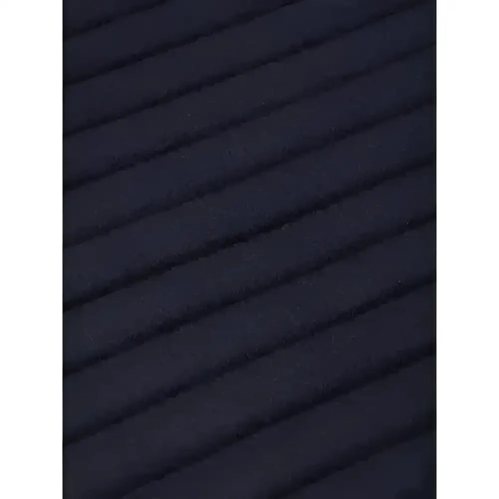 Black ribbed fabric with wavy texture on the back of lemieux memory foam bandage pads to keep horse’s legs protected