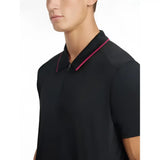 Lemieux mens performance black polo with short sleeves and vibrant pink trim on collar and placket
