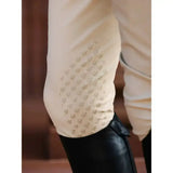Cream-colored lemieux mens pleated breech with tapered fit reduces bulk and subtle gold-toned horse head embroidery on sleeve