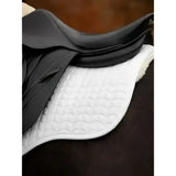 Black leather saddle resting on a lemieux merino+ lightweight cotton square with australian woolmark accredited white natural quilted pad