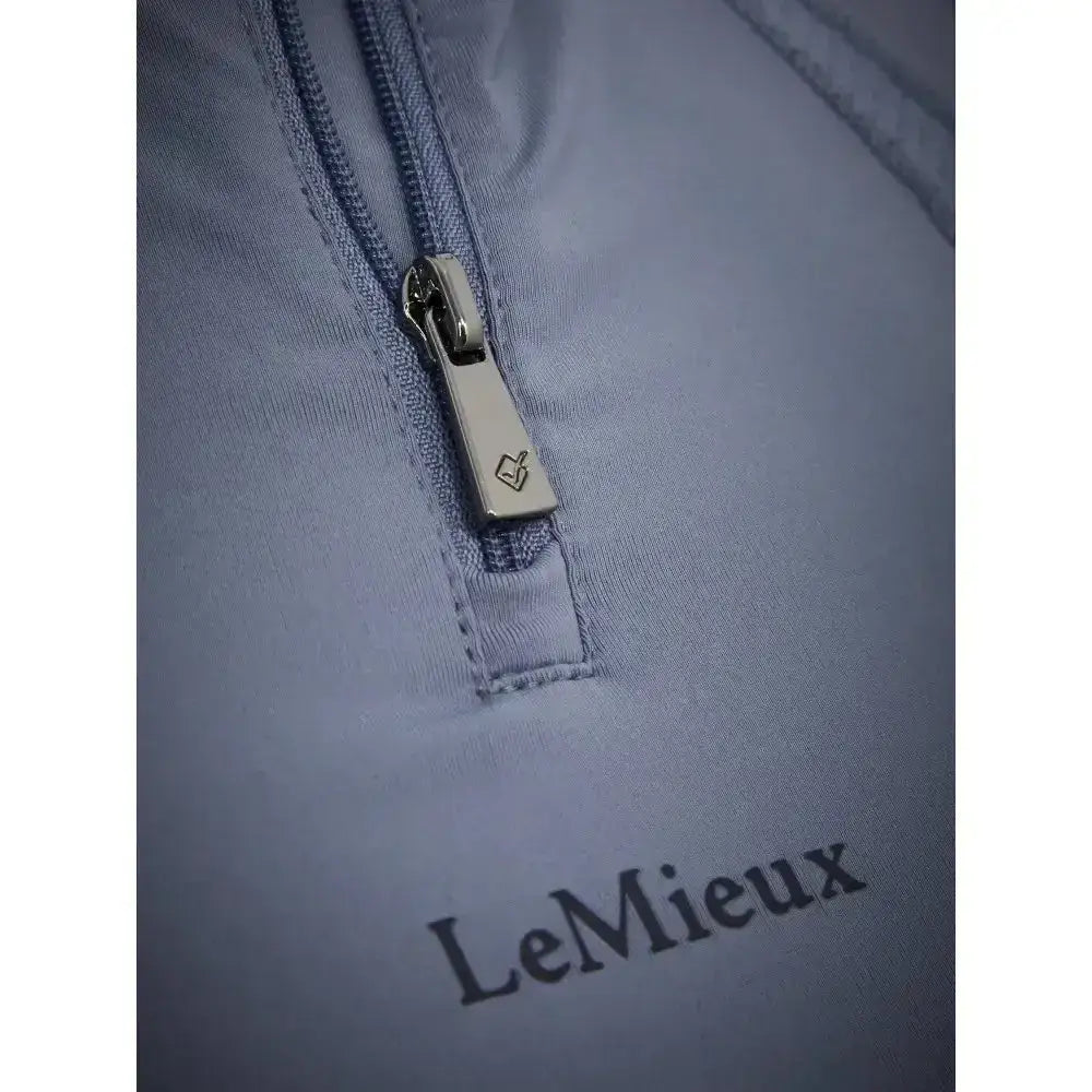 Silver zipper pull with small engraved logo on lemieux mia mesh short sleeve base layer jay blue fabric