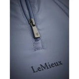 Silver zipper pull with small engraved logo on lemieux mia mesh short sleeve base layer jay blue fabric