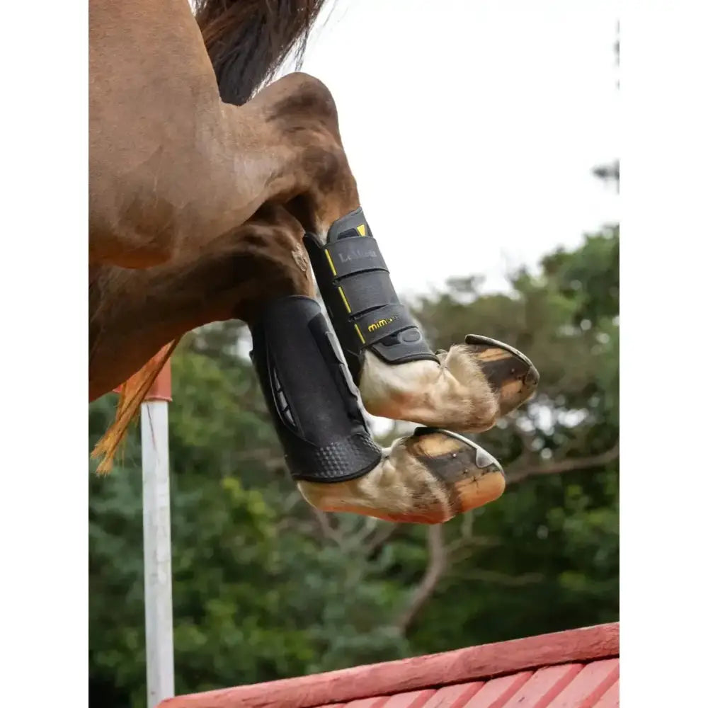 Black protective lemieux mimsafe xc boot hind black with yellow accents and adjustable straps for equestrian use