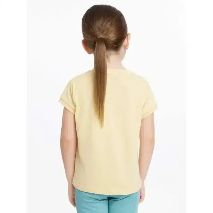 A child wearing a pale yellow lemieux mini alex short sleeved cotton tee with a simple round neckline mimosa color