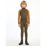 A child wearing the lemieux mini base layer alpine in olive green and mustard yellow with dark brown stripes