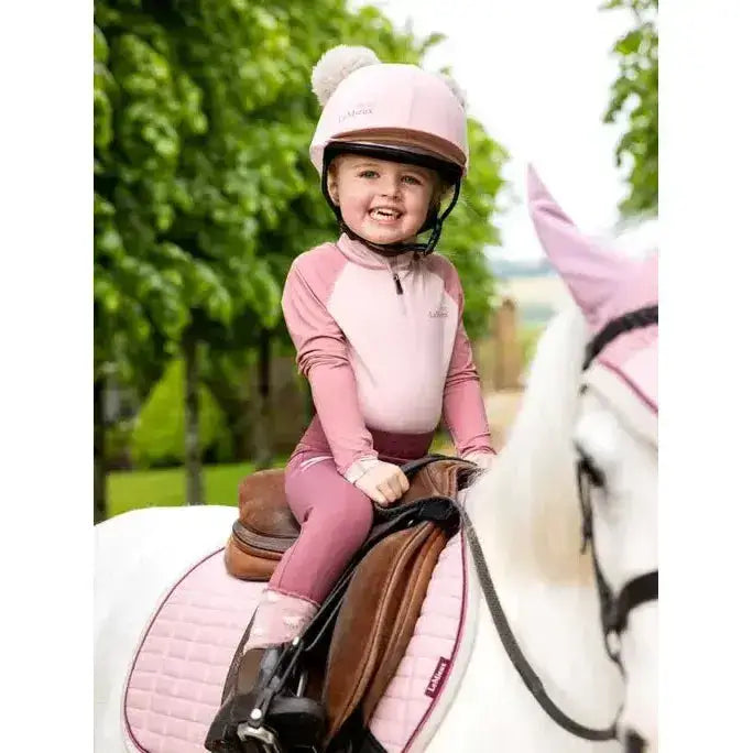 Pink lemieux mini base equestrian helmet with fluffy white pom pom in base layer blossom design