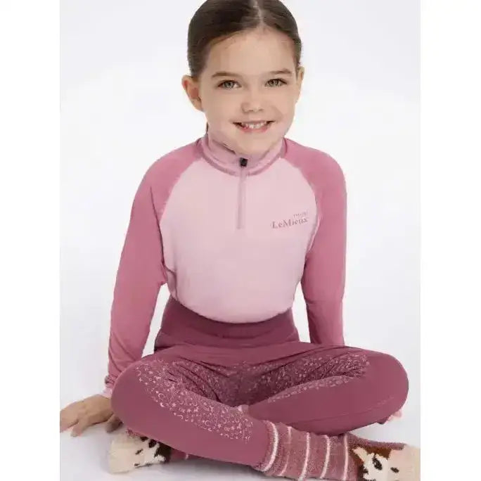Pink and mauve lemieux mini base long-sleeved athletic top with quarter-zip collar and logo on chest base layer blossom