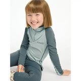 A child wearing a lemieux mini base long-sleeved glacier base layer with matching leggings for mini riders running