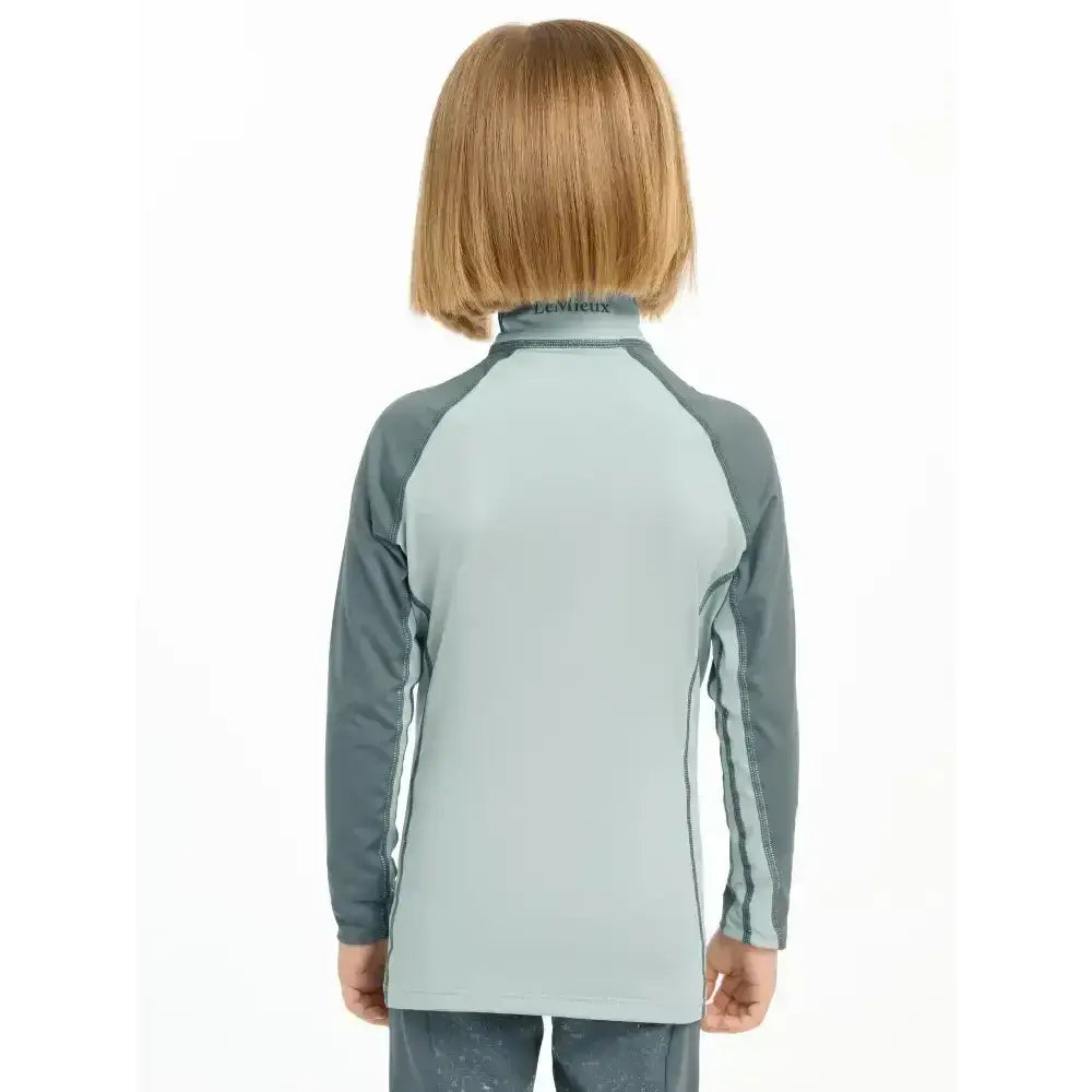 Light blue and gray lemieux mini base long-sleeved base layer glacier top with raglan sleeves for mini rider’s running
