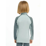 Light blue and gray lemieux mini base long-sleeved base layer glacier top with raglan sleeves for mini rider’s running