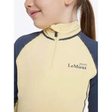 A pale yellow and navy blue long-sleeved lemieux mini base layer mimosa with mini lemieux logo on the chest